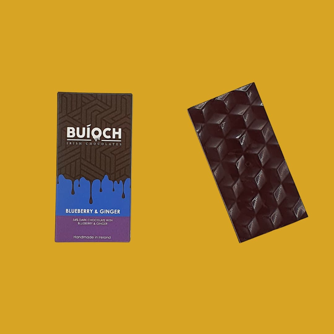 Blueberry and Ginger Bar - 54% dark chocolate with blueberries and ginger. Handmade by Buíoch Irish Chocolates. Packaging and bar on a gold background.