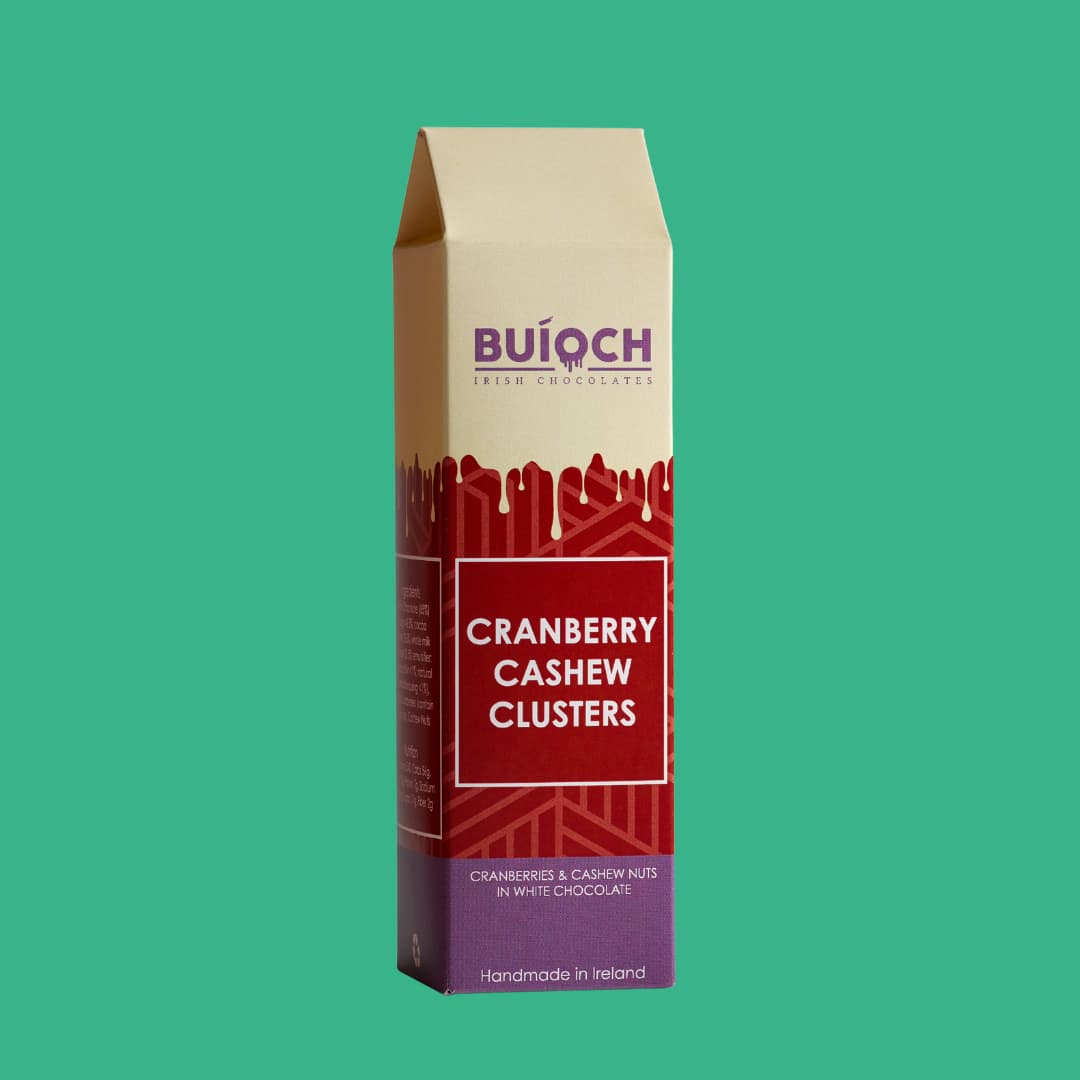 Crenberry Cashew Clusters - Cranberries and Cashew Nuts in White Chocolate. Handamde by Buíoch Irish Chocolates. Packaging on a mint green background