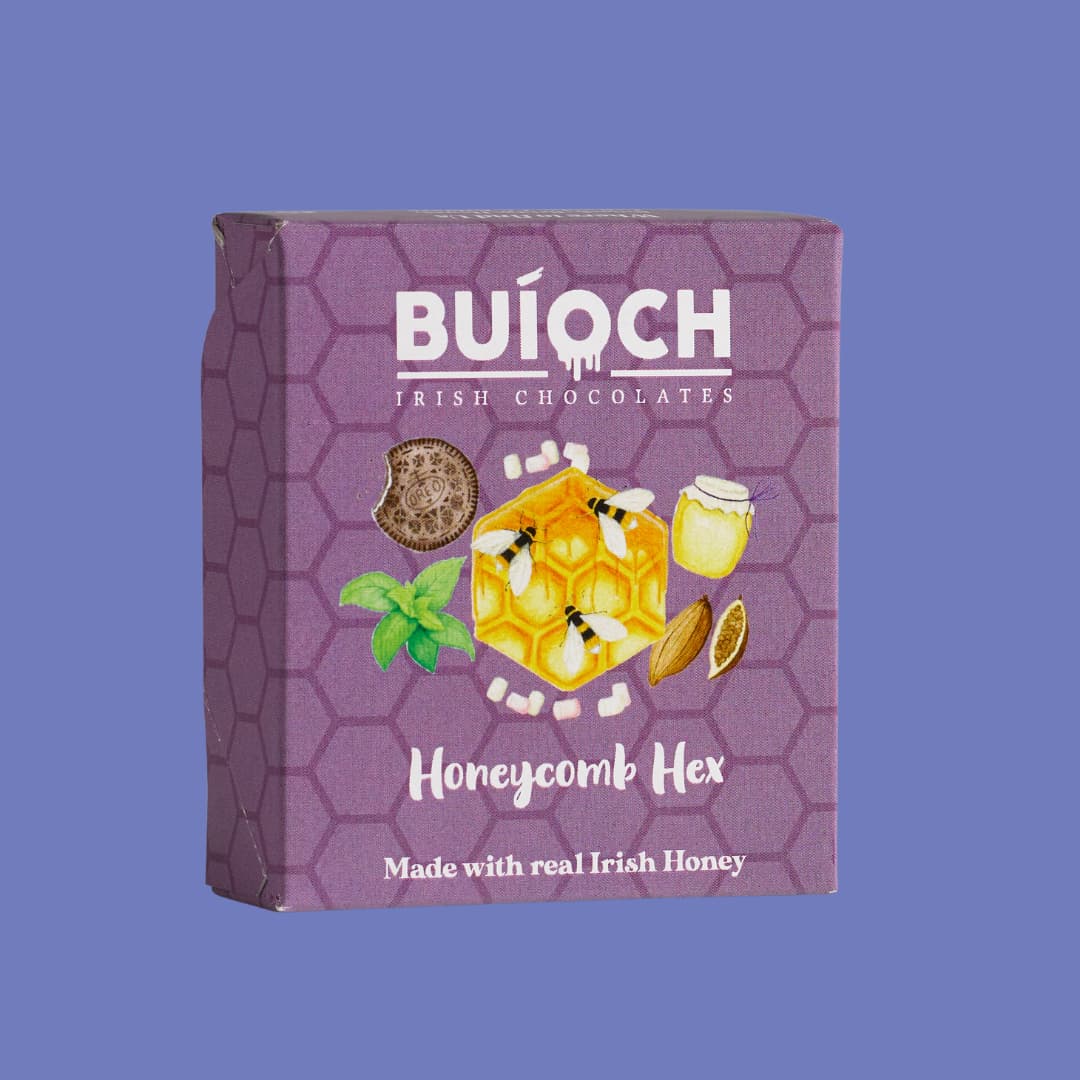 White Chocolate Honeycomb Hex - Packaging on a blue background. Handamde by Buíoch Irish Chocolates.