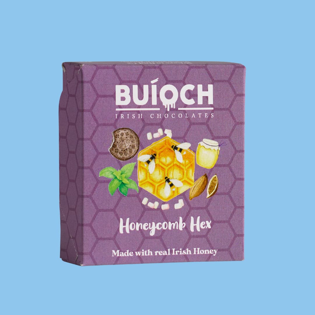 Milk Chocolate Cookies & Cream Honeycomb Hex - Packaging on a blue background. Handamde by Buíoch Irish Chocolates.