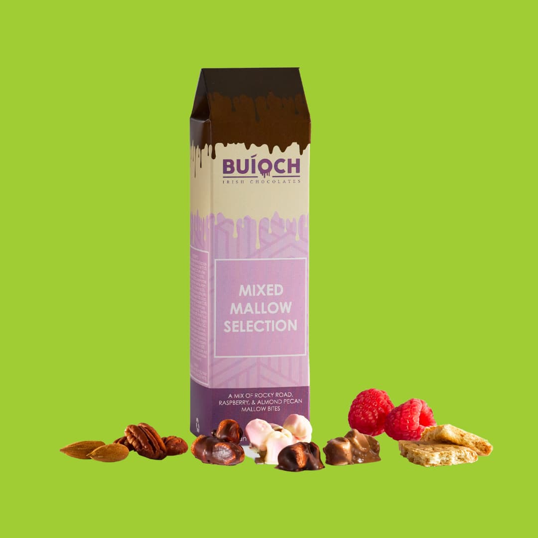 Mixed mallow selection. Milk chocolate rocky road mallow bites, white chocolate almond and pecan mallow bites and dark chocolate raspberry mallow bites. Handamde by Buíoch Irish Chocolates. Packaging, bites and ingredients on a lime green background