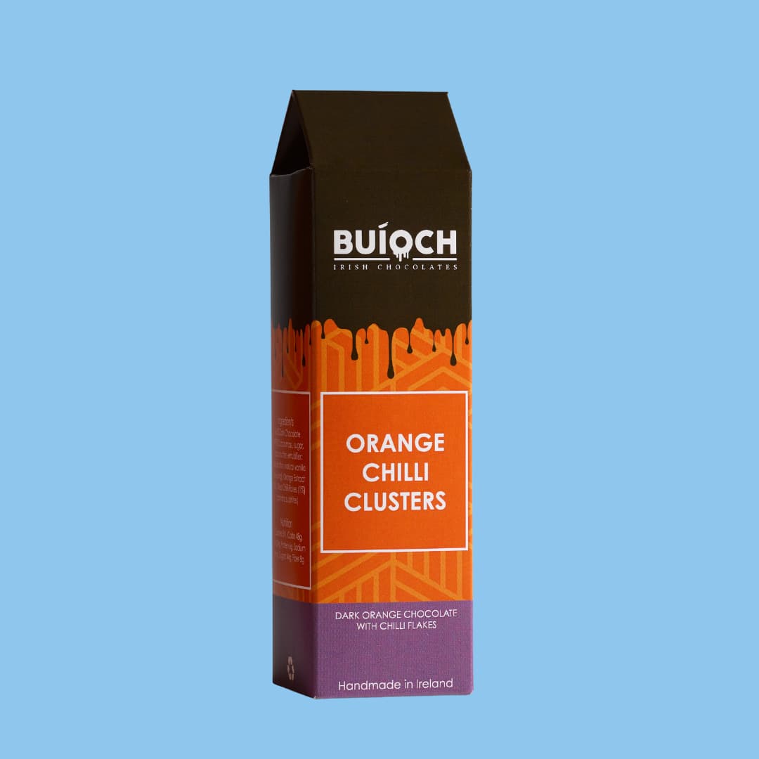 Orange Chilli Clusters - Dark orange chocolate with chilli flakes. Handamde by Buíoch Irish Chocolates. Packaging on a blue background