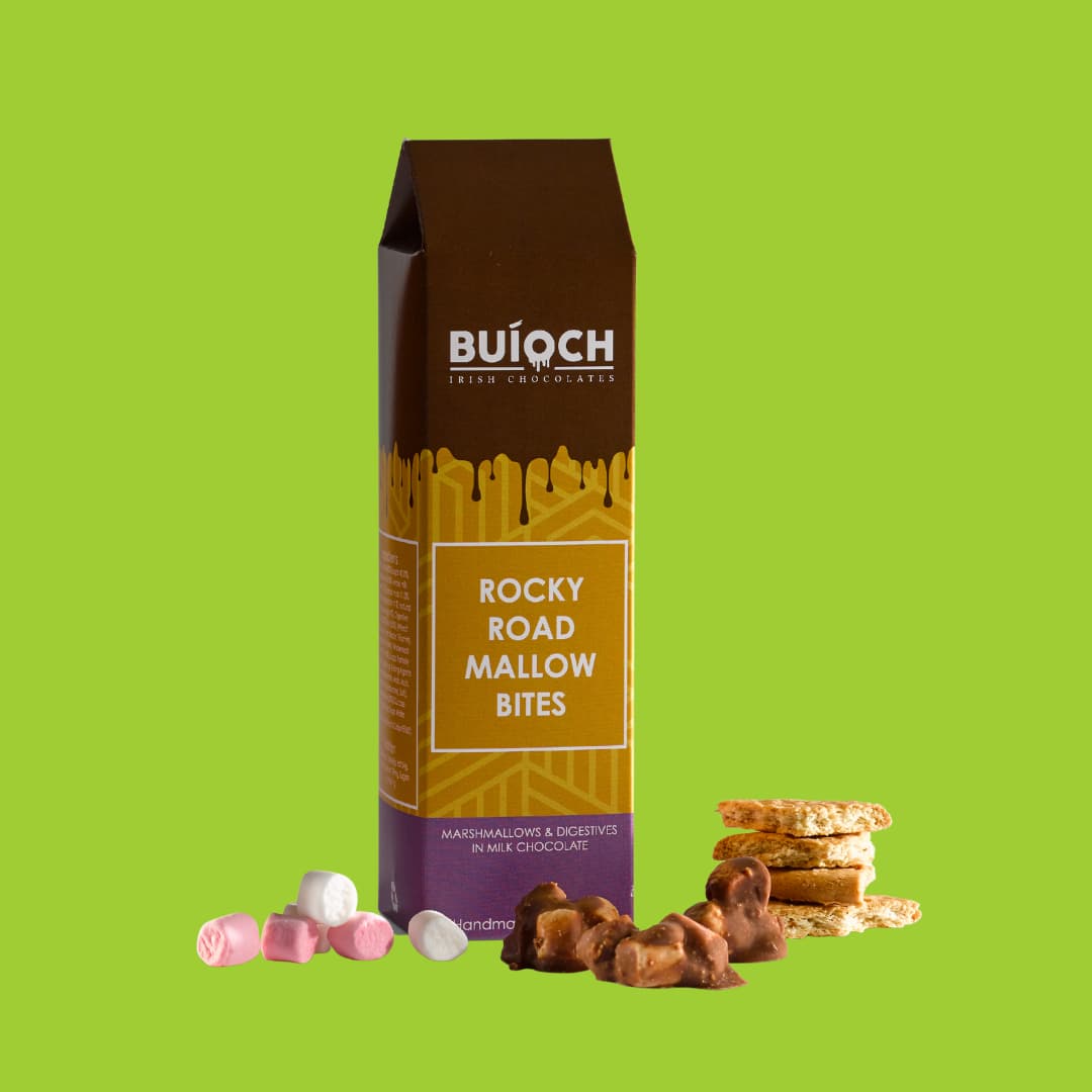 Rocky Road Mallow Bites - Marshmallow and Digestives in Milk Chocolate. Handamde by Buíoch Irish Chocolates. Packaging and ingredients on a Lime Green Background.