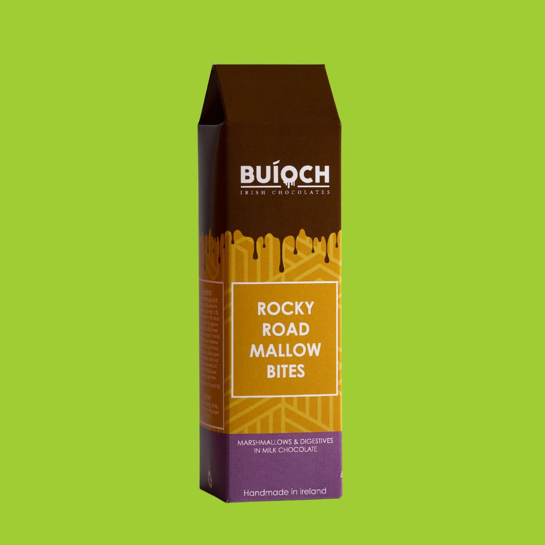 Rocky Road Mallow Bites - Marshmallow and Digestives in Milk Chocolate. Handamde by Buíoch Irish Chocolates. Packaging on a Lime Green Background.
