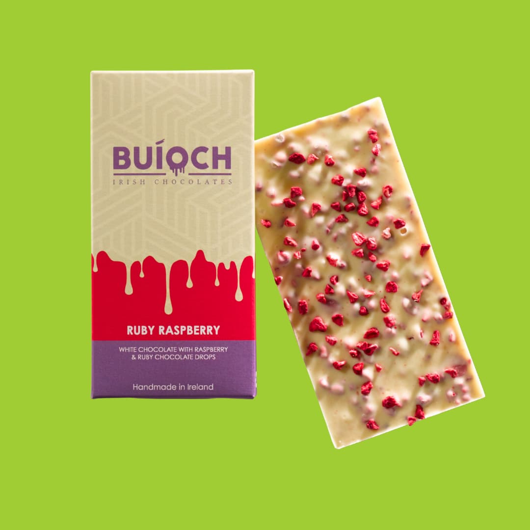 Ruby Raspberry Bar - White chocolate with raspberry and ruby chocolate drops. Handmade by Buíoch Irish Chocolates. Packaging on a lime green background.