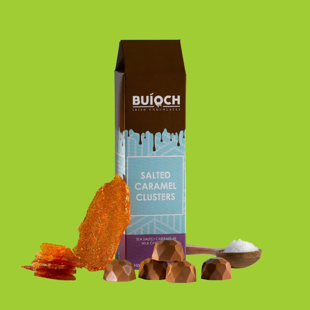 Salted Caramel Clusters - Sea salted caramel in milk chocolate. Handmade by Buíoch Irish Chocolates. Packaging, clusters and ingredients on a lime green background