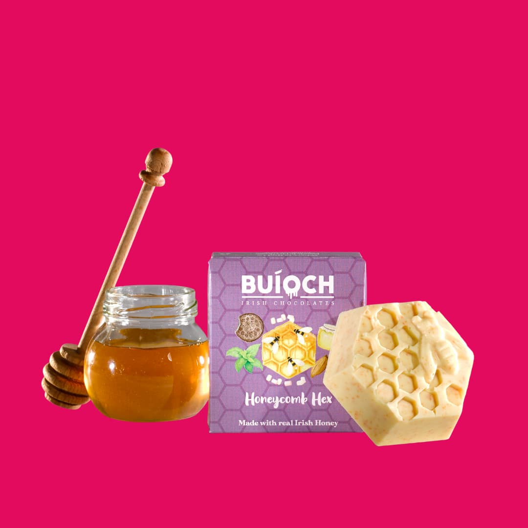 White Chocolate Honeycomb Hex - Chocolate Hex, ingredients and packaging on a pink background. Handamde by Buíoch Irish Chocolates.