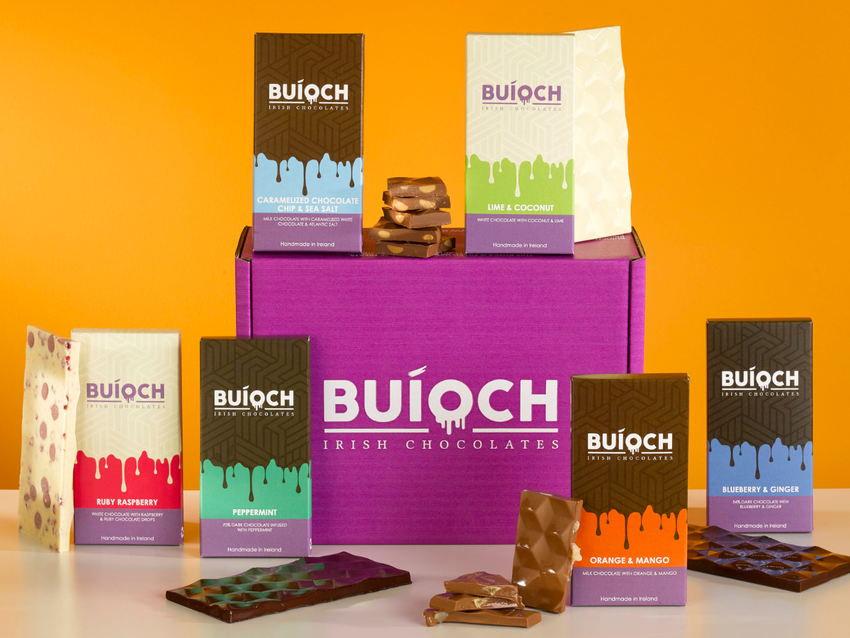 Buíoch chocolate bars and treat cartons arranged around a purple gift box