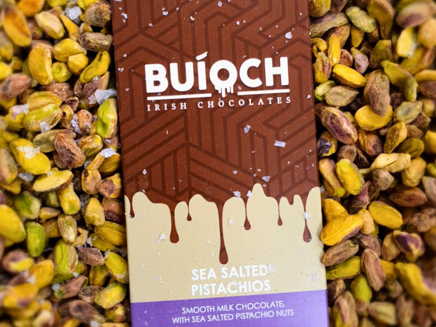 Buíoch Sea Salted Pistachio bar packaging surrounded by pistachios