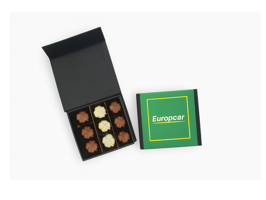 Open nine-piece chocolate gift box beside a green Europcar-branded sleeve