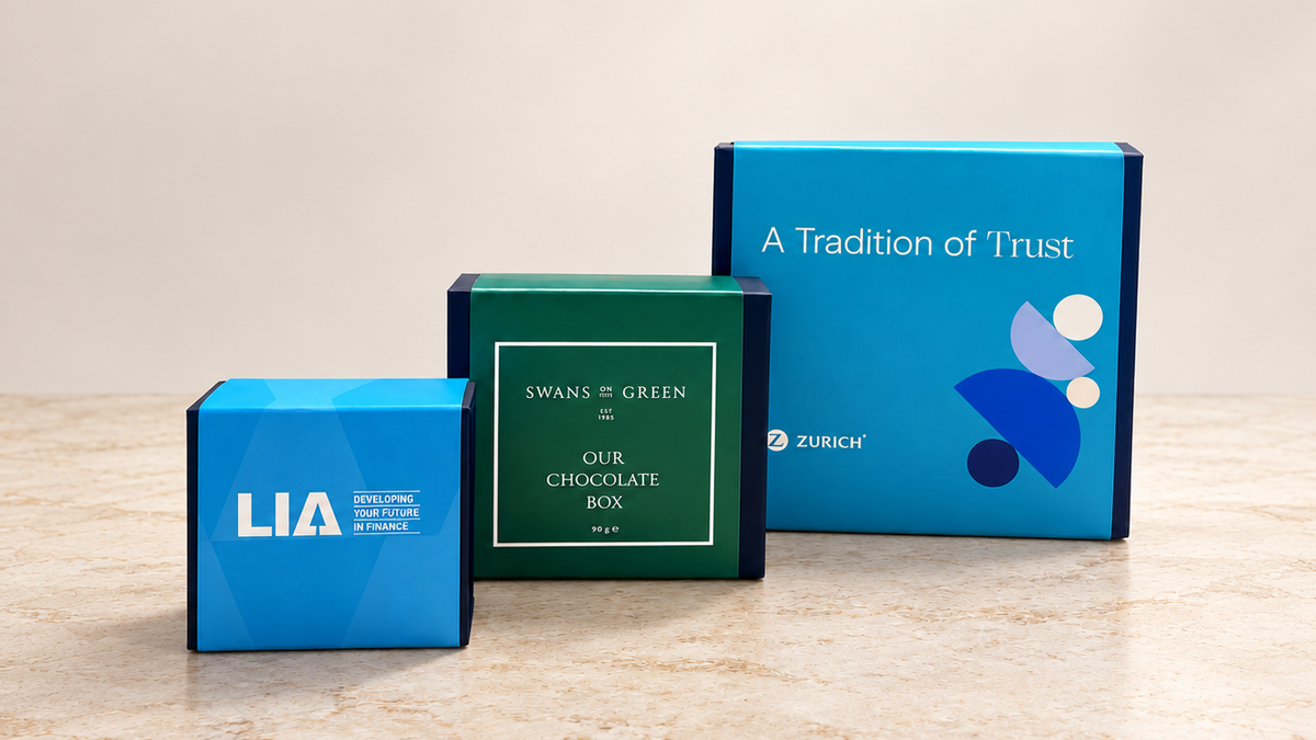 LIA, Druids Glen and Zurich-branded chocolate gift boxes on a wooden table