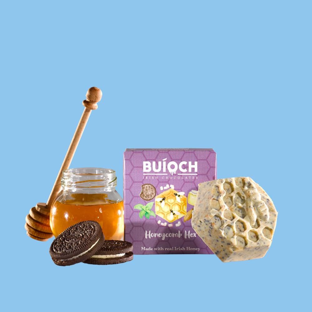 
                  
                    Cookies Cream White Chocolate Honeycomb Hex - Packaging on an blue background. Handmade by Buíoch Irish Chocolates.
                  
                