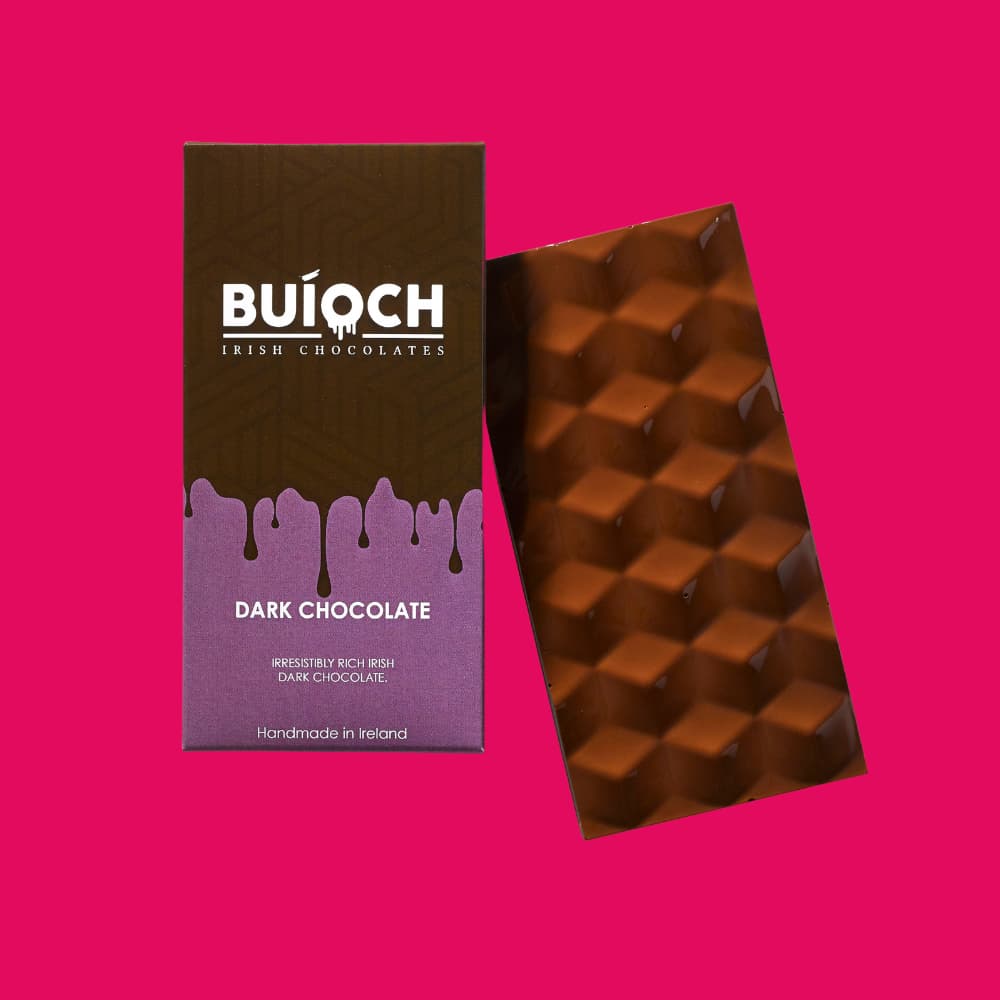 Dark Chocolate Bar. Handamde by Buíoch Irish Chocolates. Packaging and bar on a pink background.
