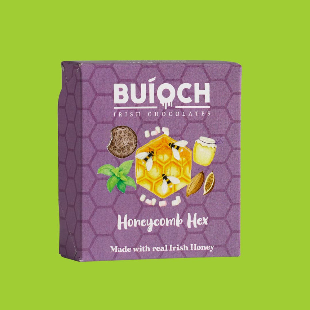 
                  
                    Milk Chocolate Honeycomb Hex - Packaging on a lime green background. Handamde by Buíoch Irish Chocolates.
                  
                