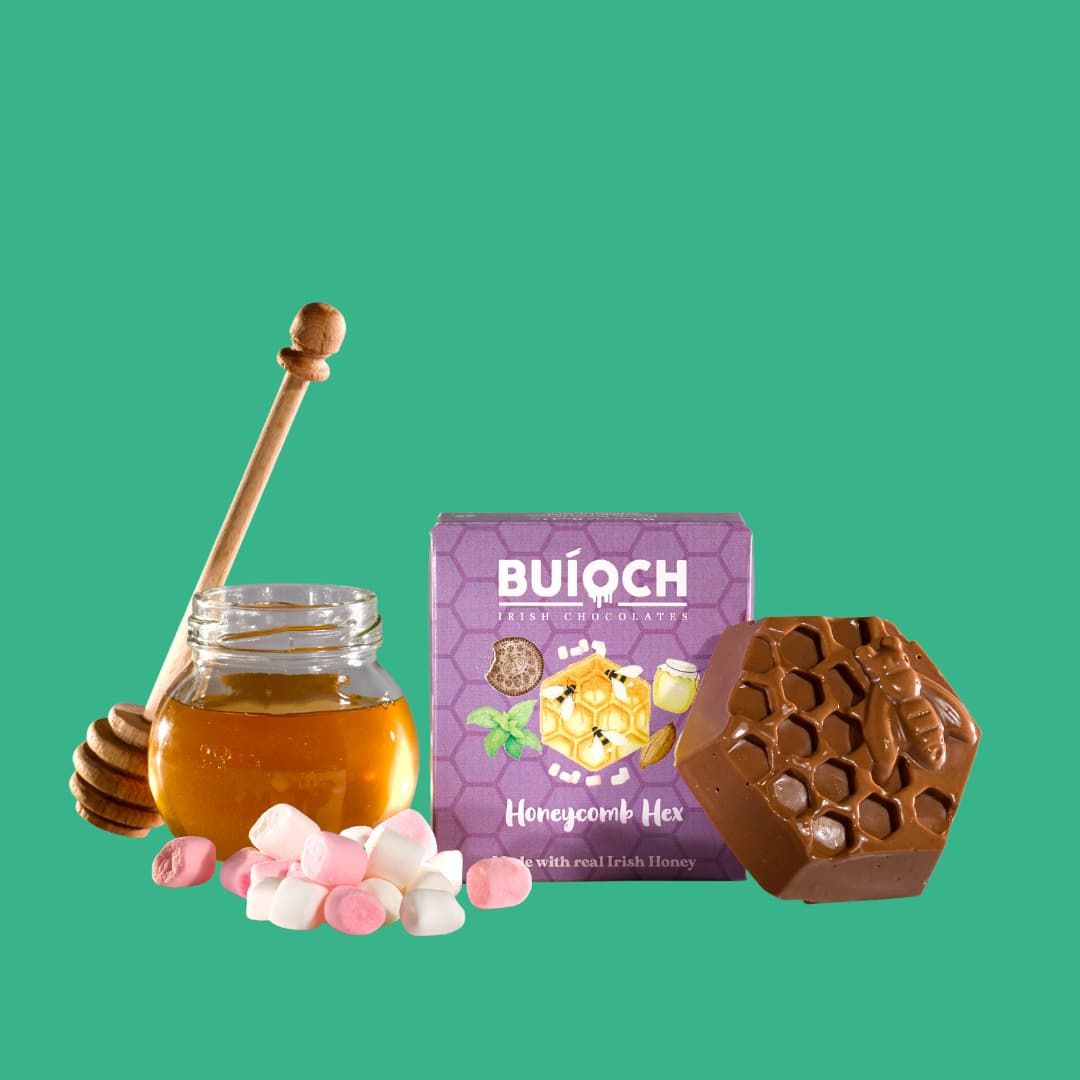 
                  
                    Marshmallow Milk Chocolate Honeycomb Hex - Packaging on a mint green background. Handmade by Buíoch Irish Chocolates.
                  
                