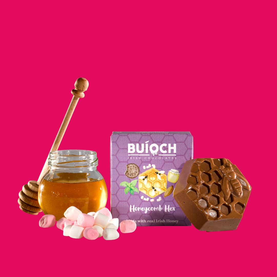 
                  
                    Marshmallow Milk Chocolate Honeycomb Hex - Packaging a pink background. Handmade by Buíoch Irish Chocolates.
                  
                