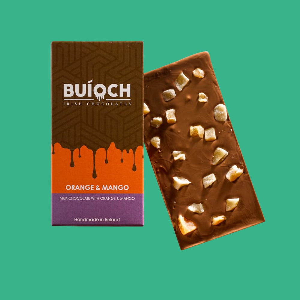 
                  
                    Orange and Mango Bar - Milk chocolate with oreange and mango. Handmade by Buíoch Irish Chocolates. Packaging and bar on a mint green background.
                  
                