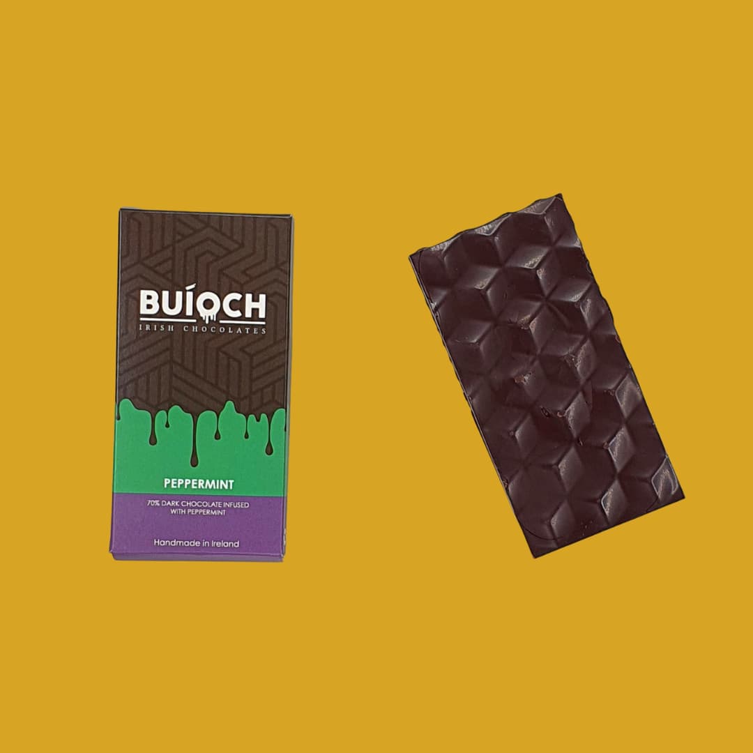 
                  
                    Peppermint Bar - 70% dark chocolate infused with peppermint. Handmade by Buíoch Irish Chocolates. Packaging and bar on a gold background.
                  
                
