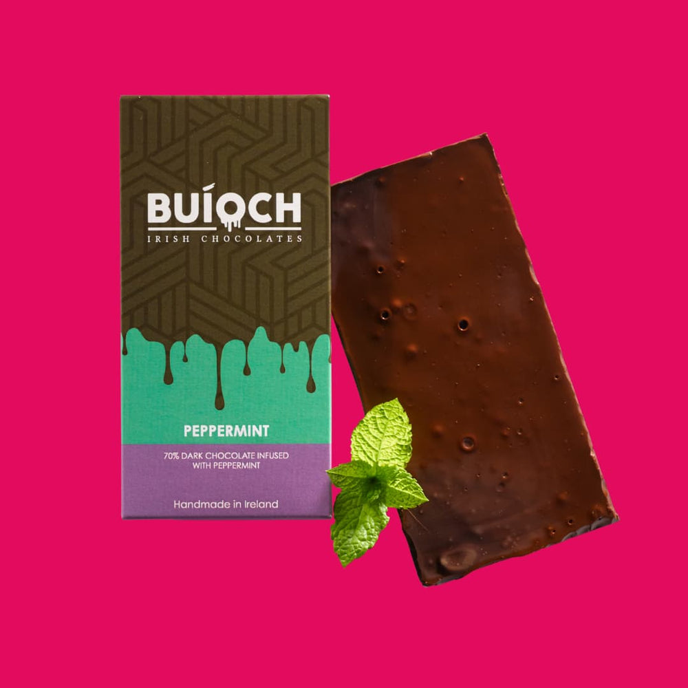 Peppermint Bar - 70% dark chocolate infused with peppermint. Handmade by Buíoch Irish Chocolates. Packaging and bar on a pink background.