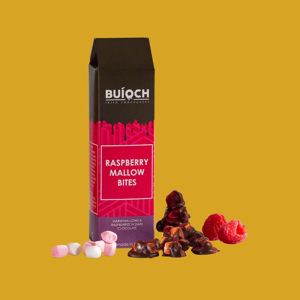 
                  
                    Raspberry Mallow Bites - Marshmallow and Raspberries in Dark Chocolate. Handamde by Buíoch Irish Chocolates. Packaging, Bites and Ingredients on a gold Background.
                  
                